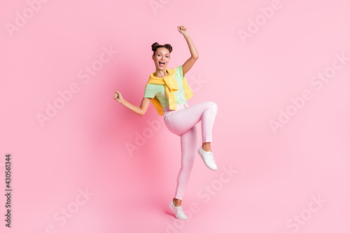 Full length photo of happy cheerful woman raise fists victory sale isolated on pink color background