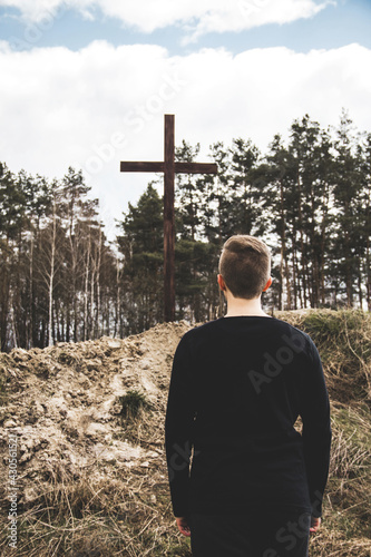 The man looks at the cross. Man believes in God. Hope in God