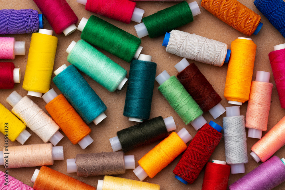 Many colored spools of threads as a background Many colored spools of threads as a background
