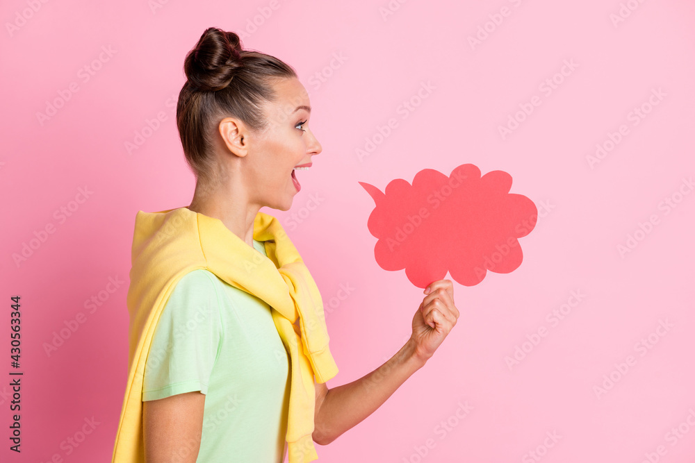 Photo of charming funny young woman wear green t-shirt holding arms idea cloud empty space isolated pink color background Photo of charming funny young woman wear green t-shirt holding arms idea cloud empty space isolated pink color background