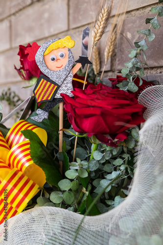 Tarragona, Spain - April 28, 2021: Roses with a Sant Jordi figurine to celebrate Sant Jordi day, the day of the book and the rose in Catalonia.