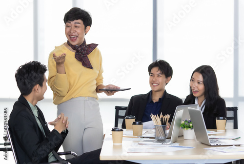 Photos A group of multi sex colleagues, tomboy, transgender and lesbian businesspeople working together with happy and intimate manner
