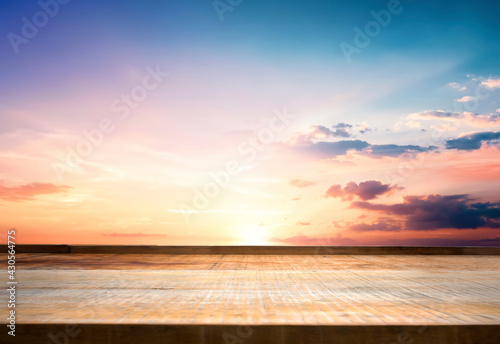 Empty top of wooden table and view of sunset  background © paul