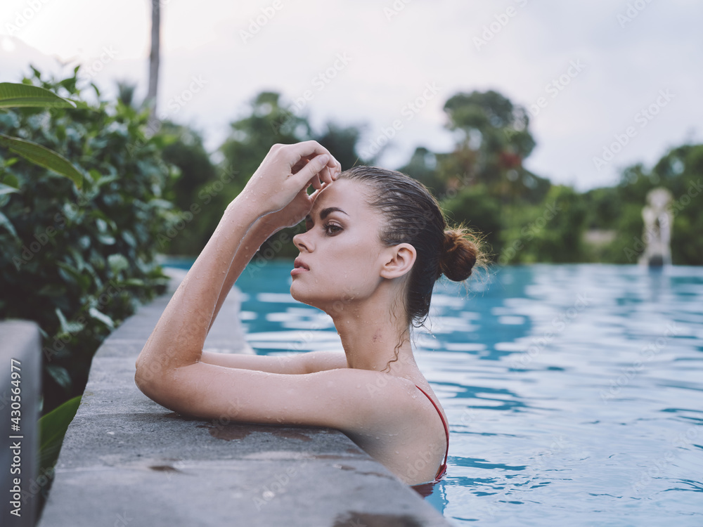 beautiful woman Swimming in the pool and red swimsuit transparent water hotel vacation model relax beautiful woman Swimming in the pool and red swimsuit transparent water hotel vacation model relax