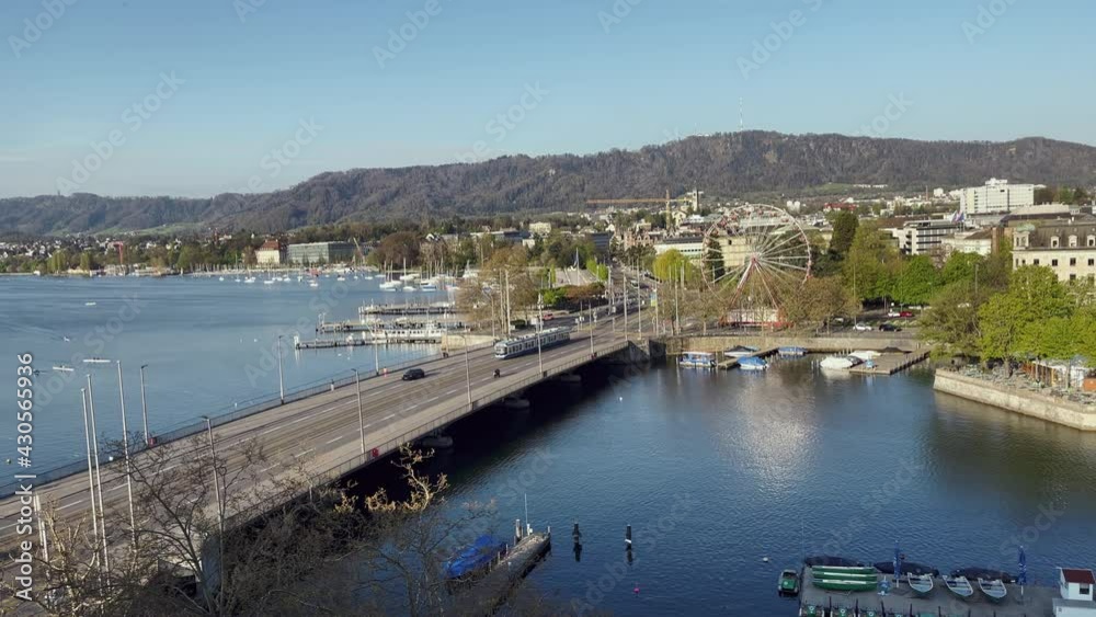 Aerial View of Zurich City and Lake with blue tram over the bridge. Aerial View of Zurich City and Lake with blue tram over the bridge.