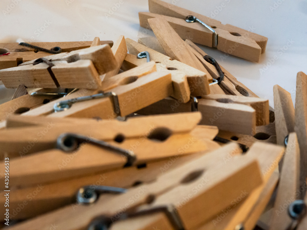 Mound of wooden clothespins on white background Mound of wooden clothespins on white background