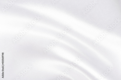 Abstract white silk fabric texture background. Cloth soft wave. Creases of satin photo