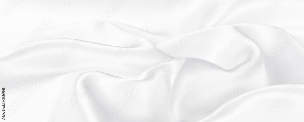 Fototapeta premium Abstract white silk fabric texture background. Cloth soft wave. Creases of satin