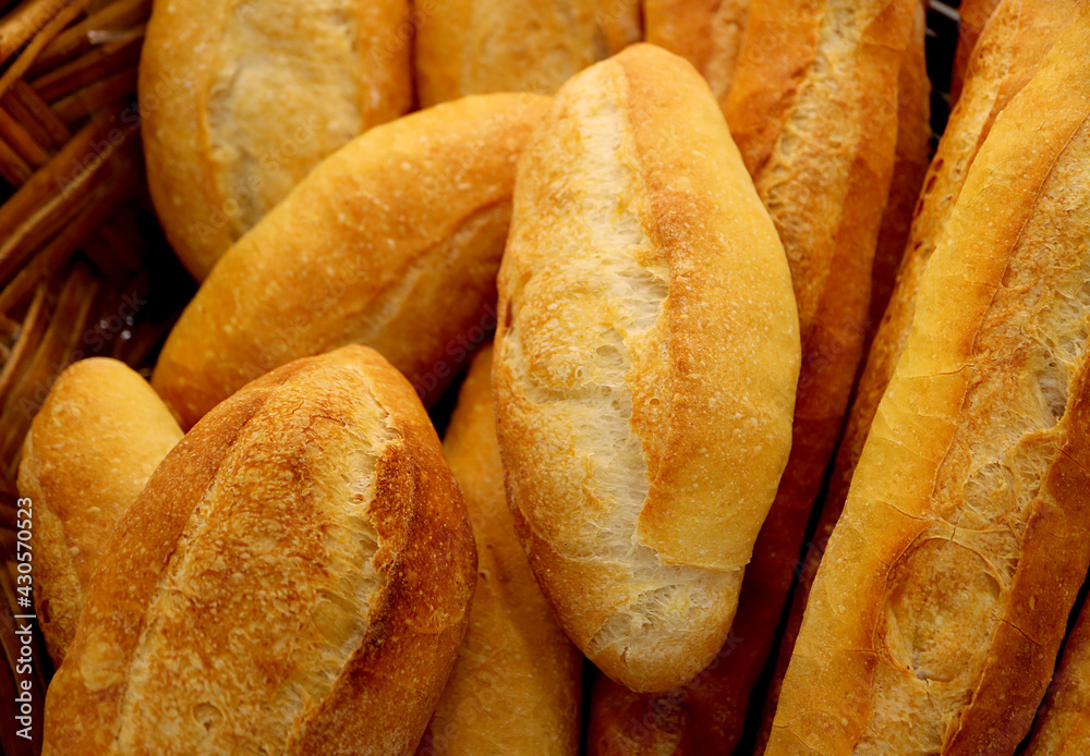 Basket of fresh baked short baguette loaves