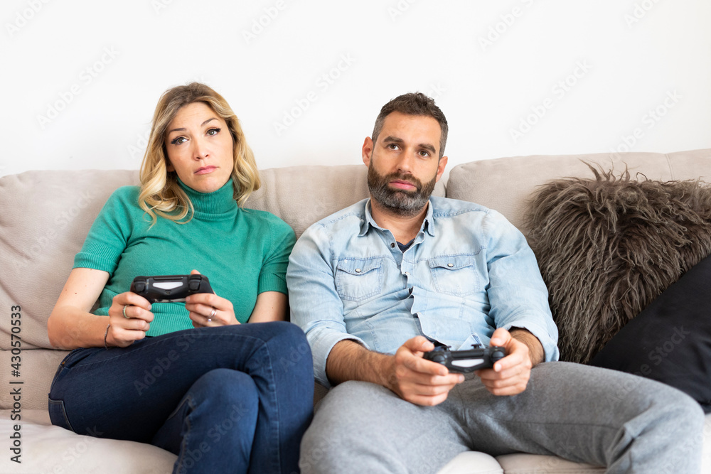 Bored couple plays the console on the sofa.
Boyfriends in front of the TV don't know how to pass the time.
Boredom and lockdown during the covid pandemic. Bored couple plays the console on the sofa.
Boyfriends in front of the TV don't know how to pass the time.
Boredom and lockdown during the covid pandemic.