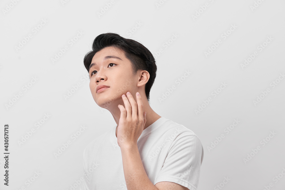 Handsome man touching his face close up portrait studio on white background Handsome man touching his face close up portrait studio on white background