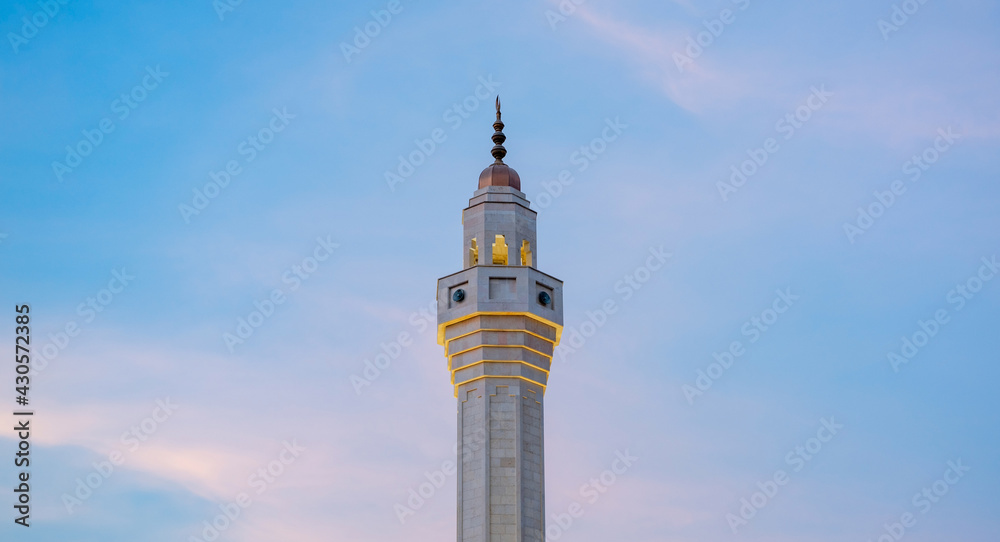 Muslim mosque minaret with dark cloud during the rainy day in Qatar