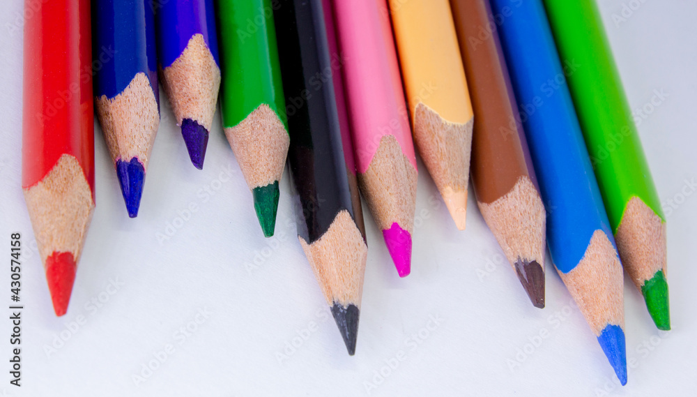 Close up macro shot of color pencil pile pencil nibs, used pencils from a school art room.