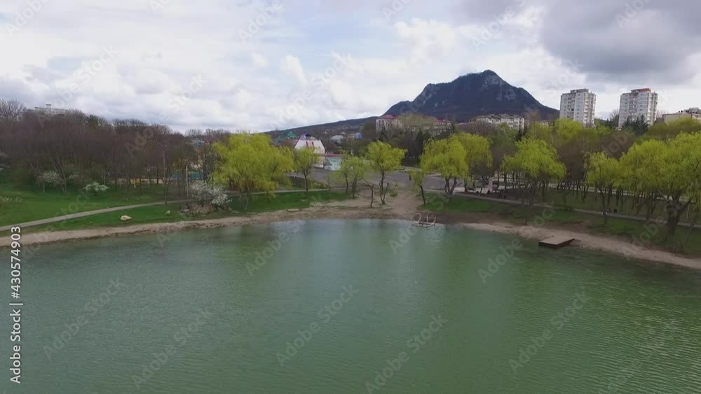 Flight over the pond overlooking the mountain and town Flight over the pond overlooking the mountain and town