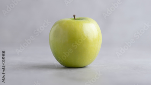 Fresh single Green Apple Isolated on Gray Background.