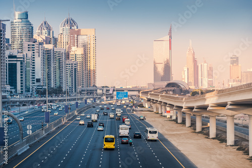 Aerial view of the famous Sheikh Zayed Road with car traffic and metro rails and numerous skyscrapers in Dubai Marina area
