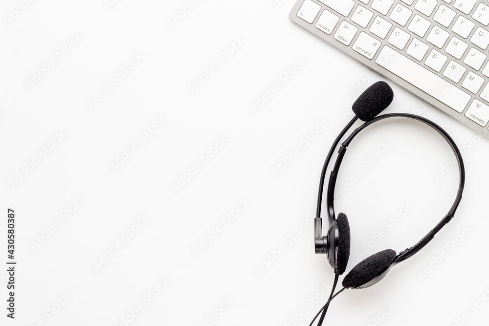 Communication support call center. Voip headset and computer laptop, top view Communication support call center. Voip headset and computer laptop, top view