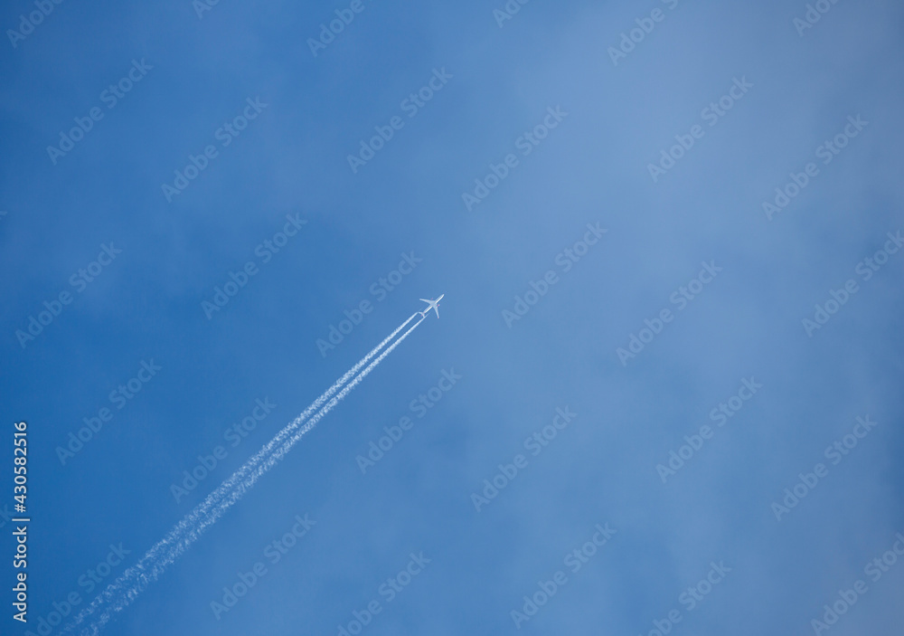 Travel concept image of an airplane flying sky high against blue sky with copy space. Travel concept image of an airplane flying sky high against blue sky with copy space.
