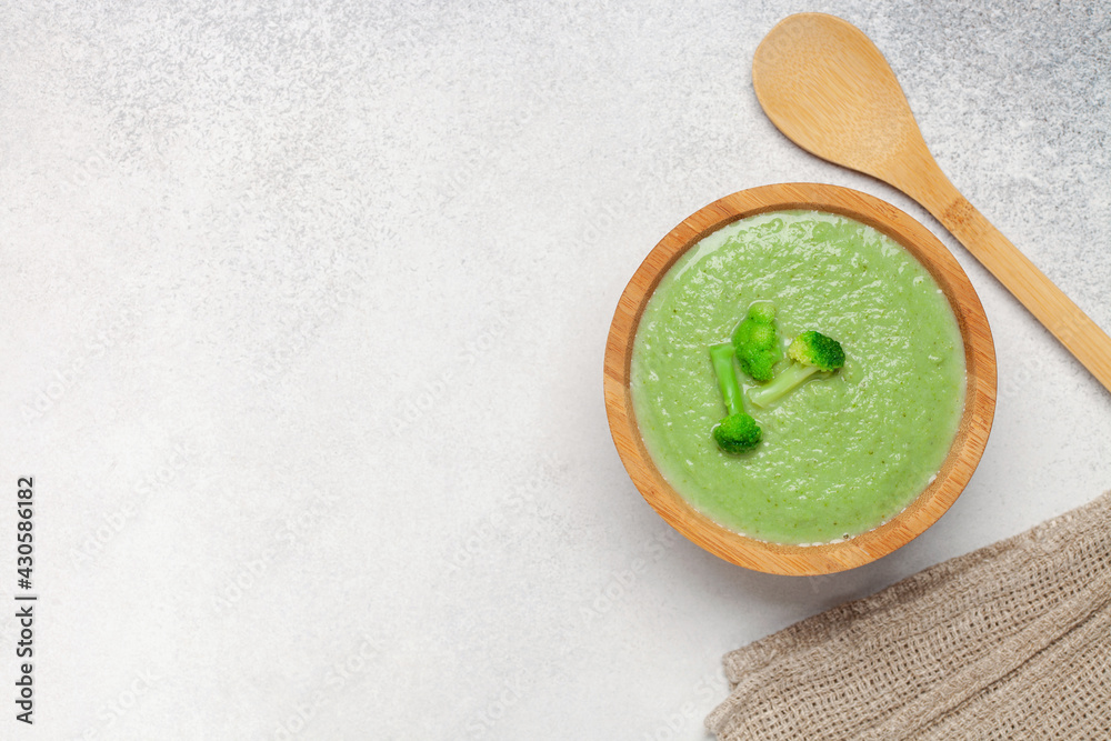 Bowl with delicious broccoli soup on table. Top view. Vegetarian and vegan food Bowl with delicious broccoli soup on table. Top view. Vegetarian and vegan food
