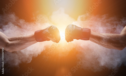 Mma fight, close up of two fists hitting each other over dark, dramatic sky with copy space.