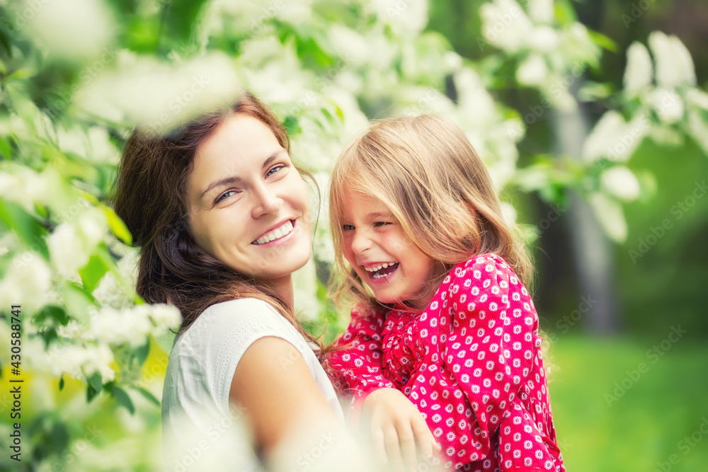 Portrait of happy mother and little daughter in spring park Portrait of happy mother and little daughter in spring park