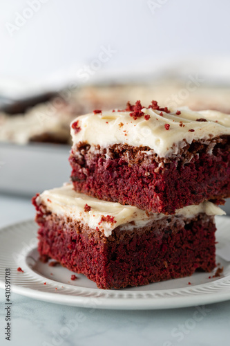 Close up straight on view of a small stack of red velvet chocolate brownies ready for eating.