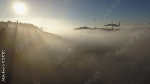 Wind turbine montait valley  in mist