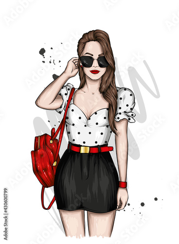 A beautiful girl in stylish clothes and with a backpack. Fashion and  Style.