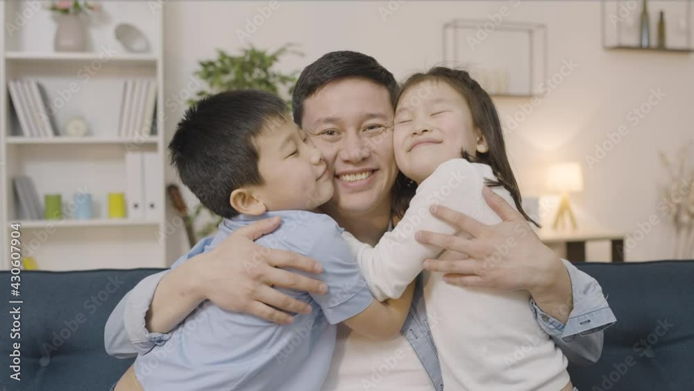 Two asian kids kissing father on cheeks and hugging, family happiness, love Two asian kids kissing father on cheeks and hugging, family happiness, love