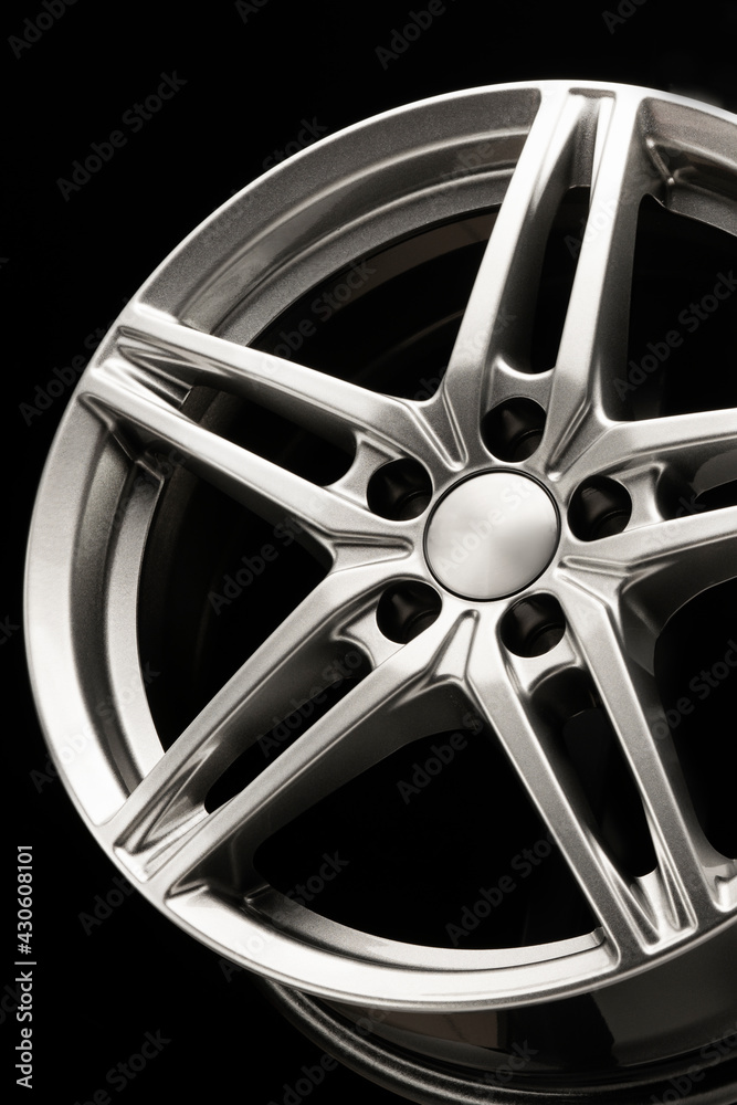 alloy wheel, sporty alloy, star-shaped on dark background, details close-up vertical photo