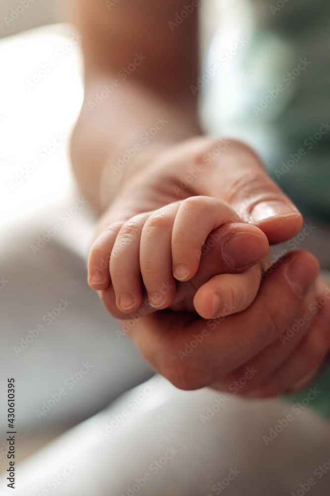 Baby's palm in the father's hand.Father's Day concept.Close-up,selective focus. Baby's palm in the father's hand.Father's Day concept.Close-up,selective focus.