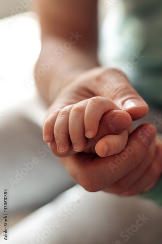 Baby's palm in the father's hand.Father's Day concept.Close-up,selective focus.