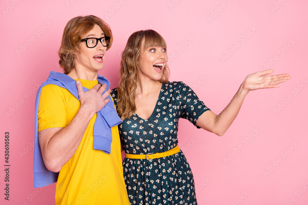 Profile photo of astonished guy hand on chest pretty lady look arm indicate empty space isolated on pink color background Profile photo of astonished guy hand on chest pretty lady look arm indicate empty space isolated on pink color background