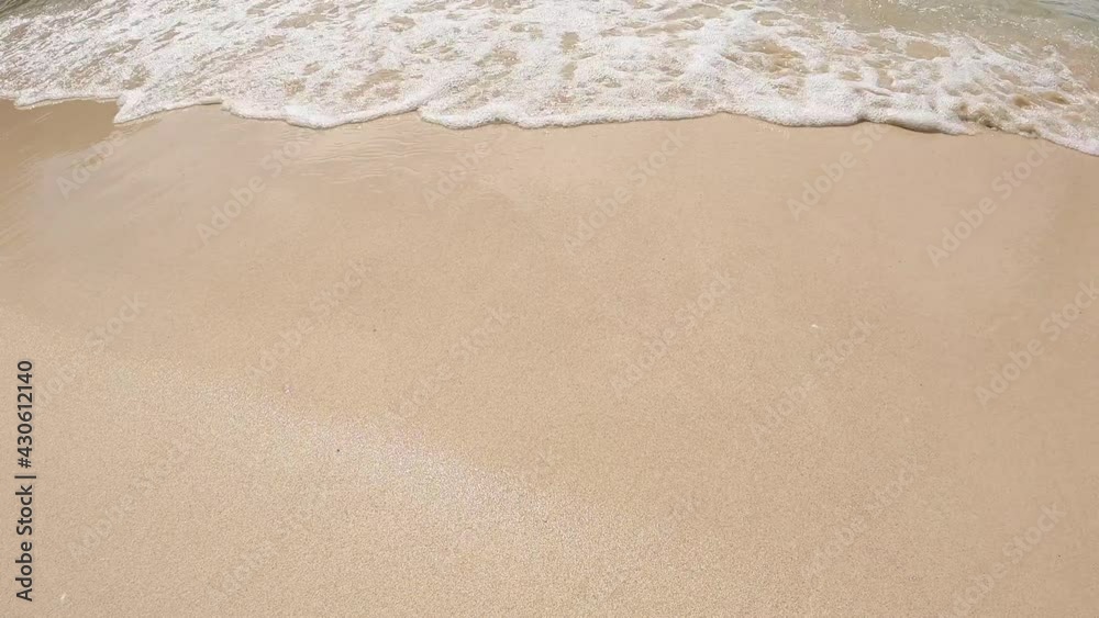 Beach top view with wave foam. 4k stock footage of blue color of ocean water, sea surface. Soft blue ocean wave on sandy beach, turquoise waves, clear water surface texture. Nature background