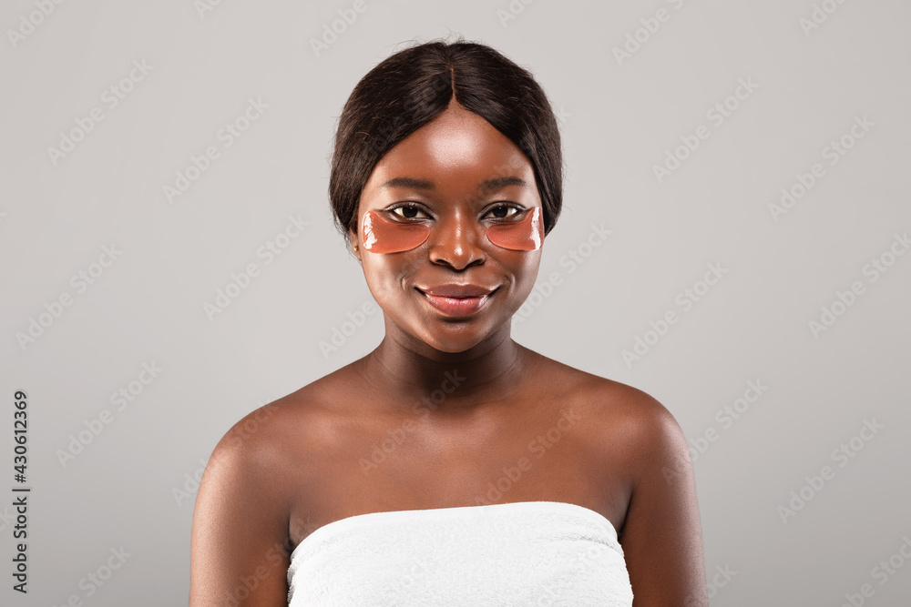 Reduce Dark Circles. Attractive Black Female Posing With Applied Eye