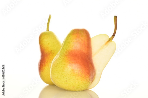 One half and two whole organic ripe, yellow pears, close-up, isolated on white.