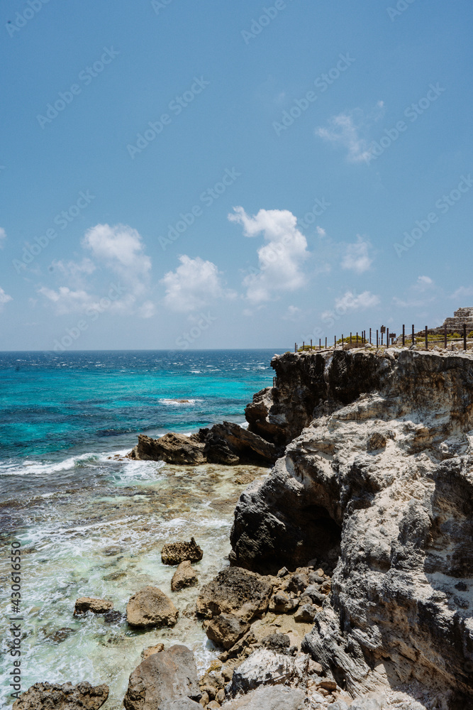 Isla Mujeres, Mexico cliff and water with blue colours. Sunny weather.
