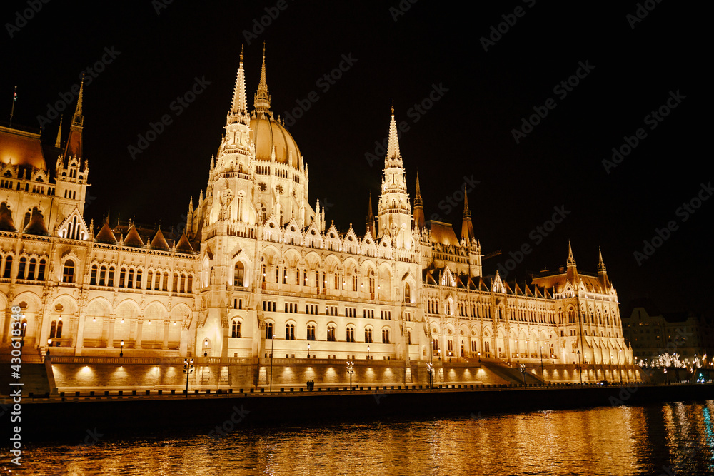 Panoramic view of the Parliament building in beautiful night lighting in Budapest. Left side