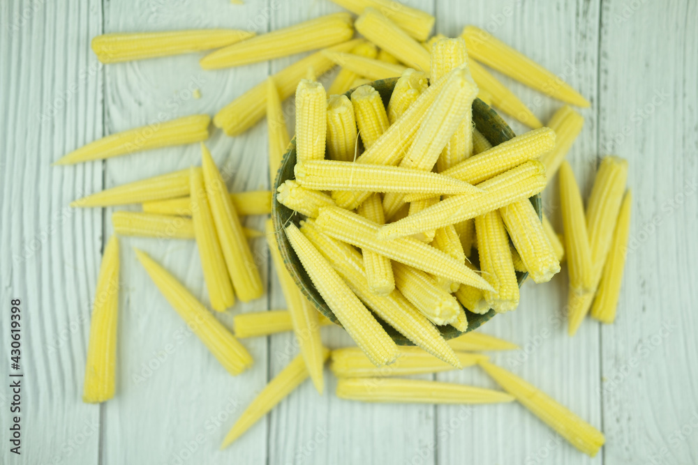 Pile fresh young baby corn in bowl Pile fresh young baby corn in bowl