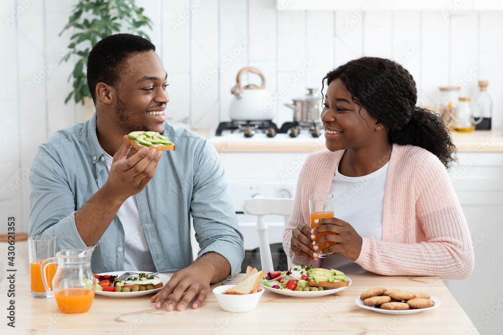 Domestic Morning. Romantic Black Man And Woman Eating Breakfast In Kitchen Domestic Morning. Romantic Black Man And Woman Eating Breakfast In Kitchen