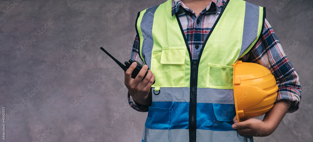 Professinal of workers holding hard hat and walkie talkie before engineers rested on site after their hard work. Teamwork engineer work together in a construction building. Safety first Professinal of workers holding hard hat and walkie talkie before engineers rested on site after their hard work. Teamwork engineer work together in a construction building. Safety first
