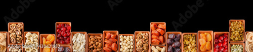 Photos Horizontally Seamless flat lay food frame of dehydrated fruits, seeds and nuts on black