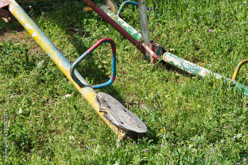 abandoned playground, damaged seesaw