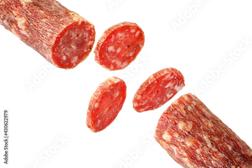 Dry meat sausage cutaway isolated on white background. Thin rings of delicious sausage.