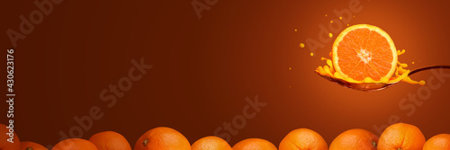 Sliced orange fruit in a spoon with pile of oranges. Background with copy space.