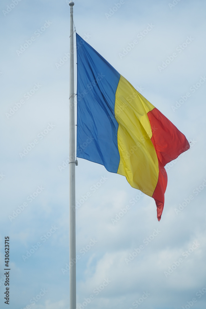 the flag of Romania waving. photo during the day. the flag of Romania waving. photo during the day.