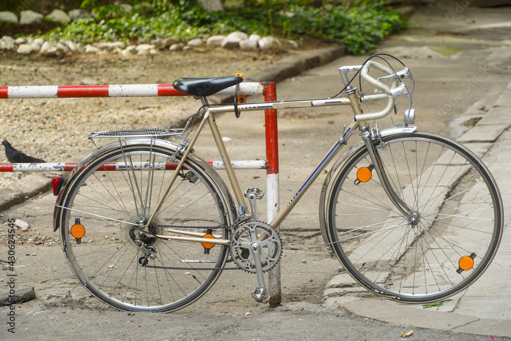 
bicycle parked near a barrier. photo during the day.