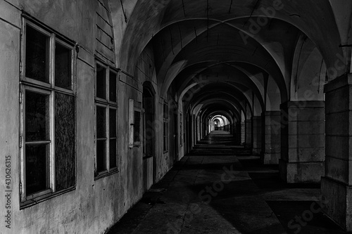 ancient arcade in the center of Prague in black and white at night illuminated by street lights