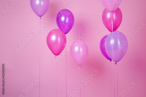 floating Colorful pink party balloons on pink pastel background. Space for text. Minimal idea creative concept of happiness, joy, birthday. holiday web banner with copy space