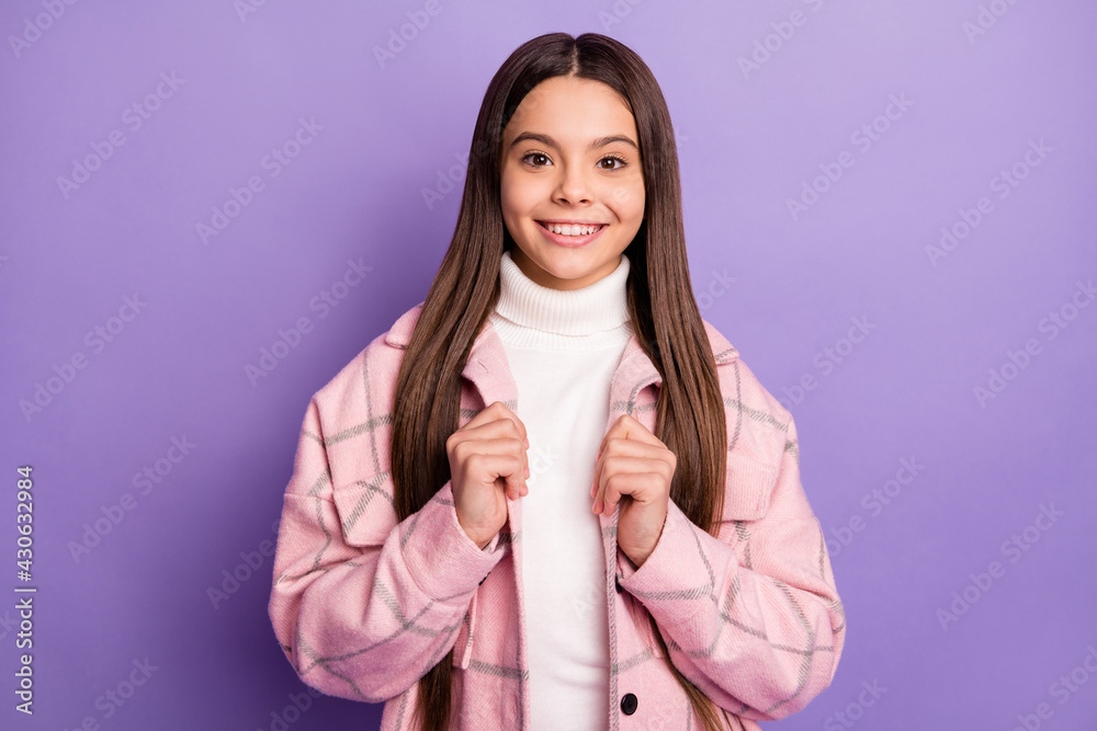 Portrait of charming cheerful girl wearing checked coat autumn fall isolated over bright violet purple color background Portrait of charming cheerful girl wearing checked coat autumn fall isolated over bright violet purple color background